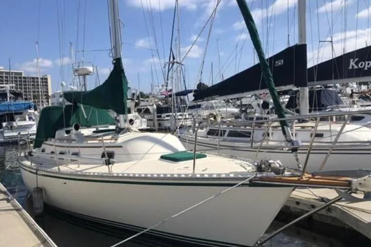 Slide: The Image of Sailboat docked at marina, 1991 Caliber 33 model, with green sail covers. - 4