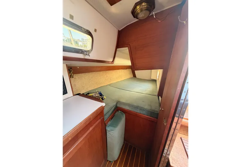 Slide: The Image of Cozy cabin interior of 1991 Caliber 33 sailboat with wooden finish and cushioned bed. - 36