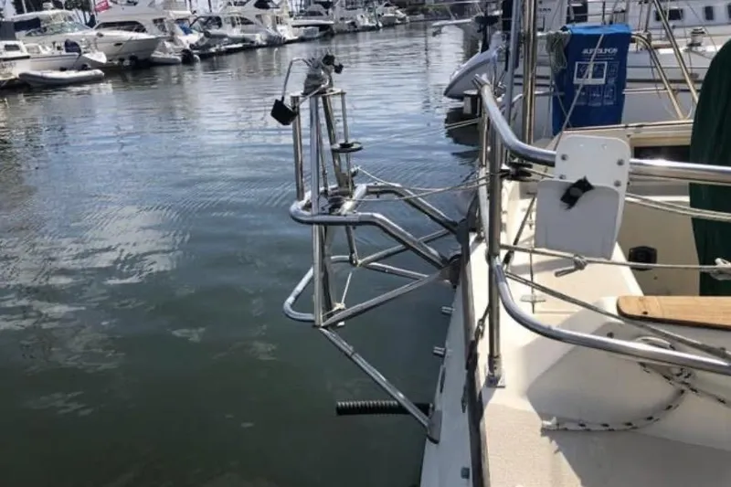 Slide: The Image of Sailboat docked in marina, featuring stainless steel railings and equipment. Caliber 33, 1991 model. - 42