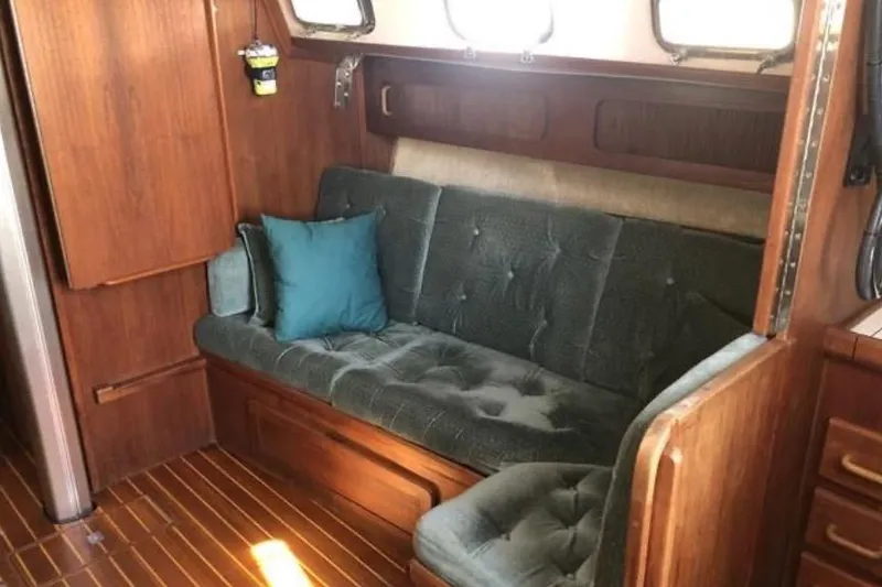 Slide: The Image of Interior of a 1991 Caliber 33 sailboat with wooden paneling and cushioned seating. - 47