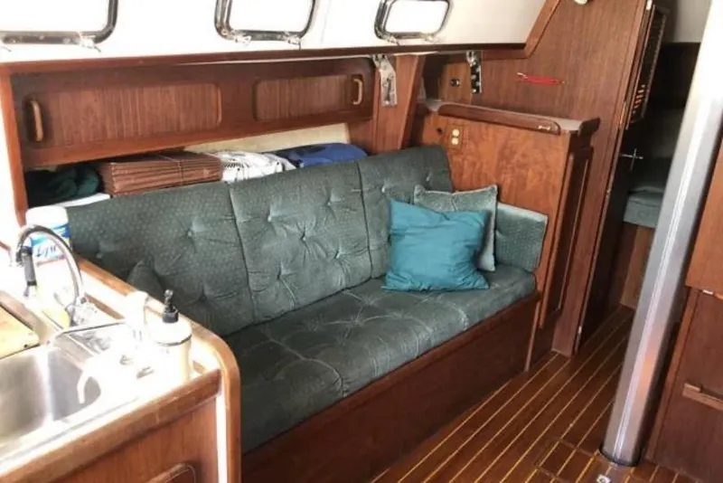 Slide: The Image of Interior of a 1991 Caliber 33 sailboat with cozy seating and wooden finishes. - 48