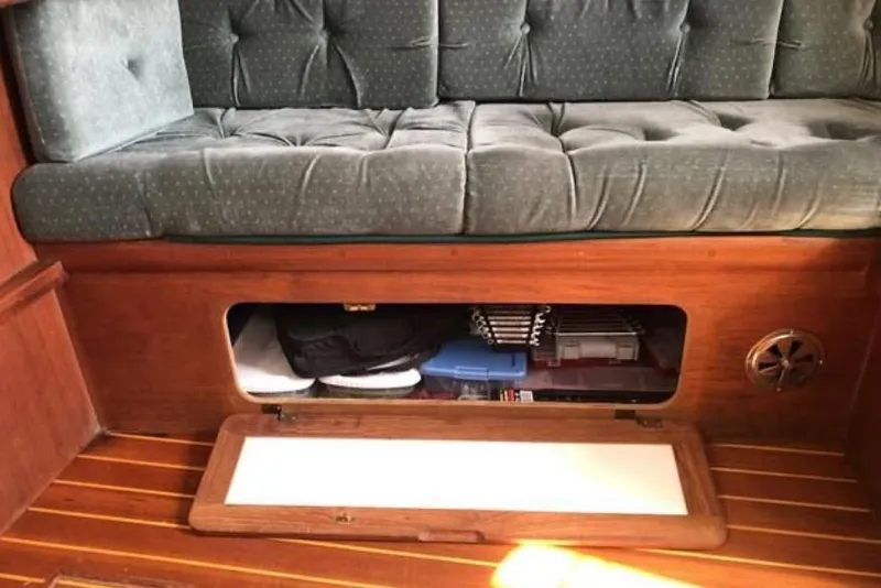 Slide: The Image of 1991 Caliber 33 interior with cushioned seating and under-seat storage compartment. - 50