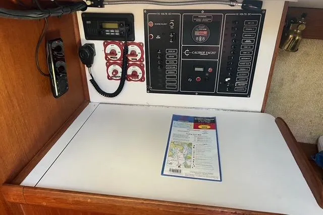 Slide: The Image of Control panel of a 1991 Caliber 33 yacht with navigation chart. - 53