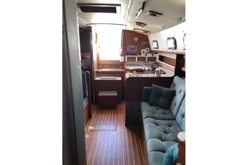 Slide: The Image of Interior of a 1991 Caliber 33 sailboat with cozy seating and wooden flooring. - 56