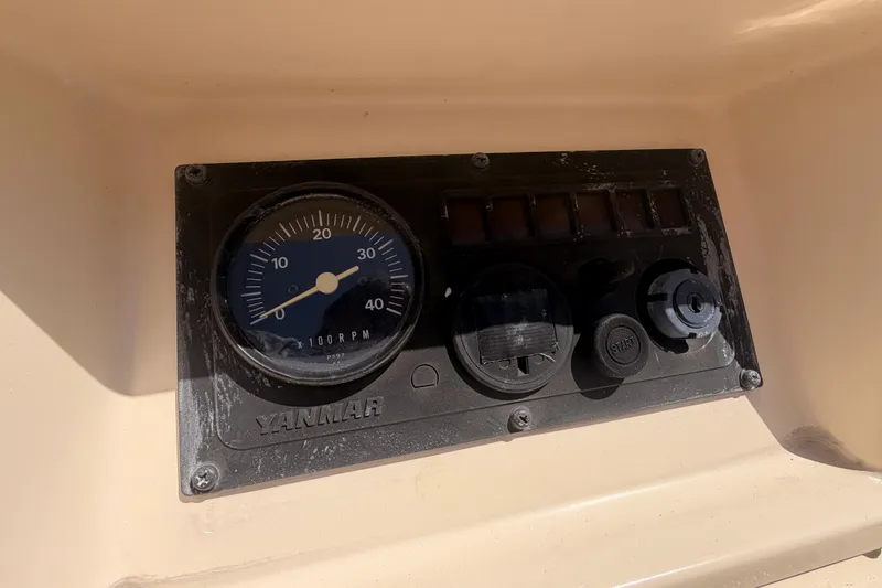 Slide: The Image of Control panel of a 1991 Caliber 33 sailboat with Yanmar tachometer. - 23