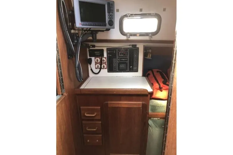 Slide: The Image of Interior of a 1991 Caliber 33 sailboat with navigation equipment and wooden cabinetry. - 61