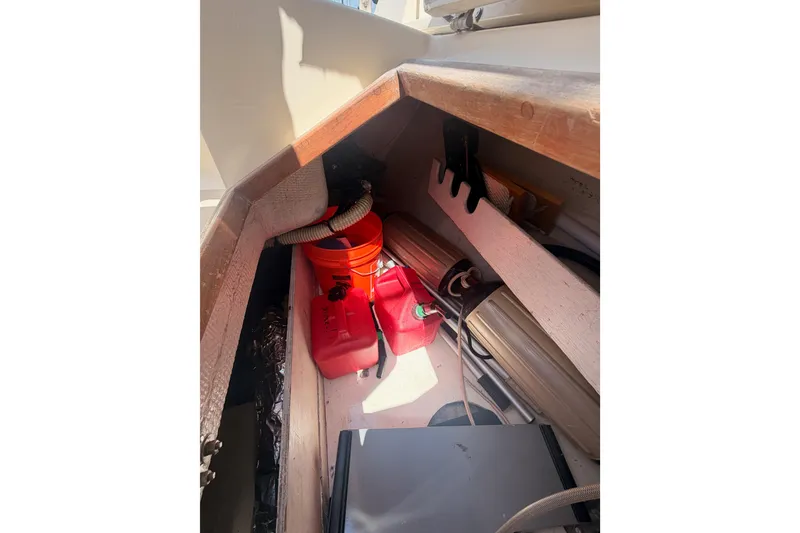 Slide: The Image of Storage compartment in a 1991 Caliber 33 sailboat with fuel containers and equipment. - 29