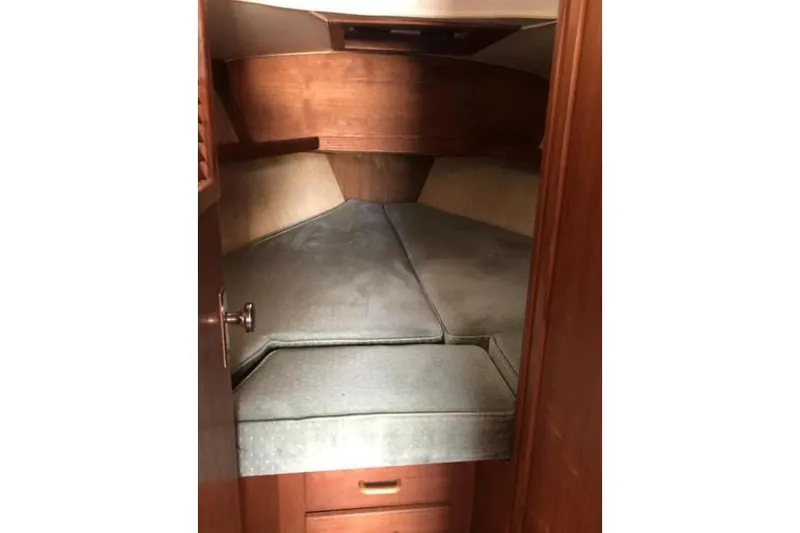 Slide: The Image of Cozy cabin interior of 1991 Caliber 33 sailboat with cushioned berth. - 64