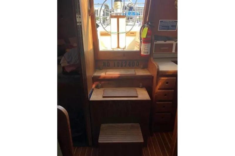 Slide: The Image of Interior of 1991 Caliber 33 sailboat with wooden steps and fire extinguisher. - 65