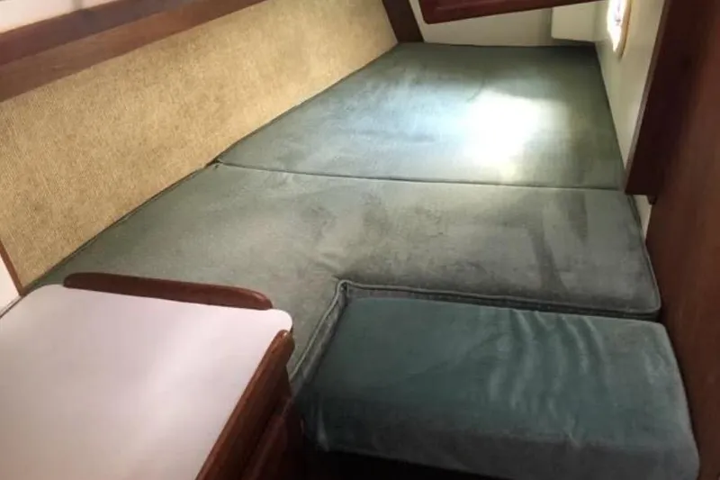 Slide: The Image of Interior cabin of a 1991 Caliber 33 sailboat with cushioned seating. - 68