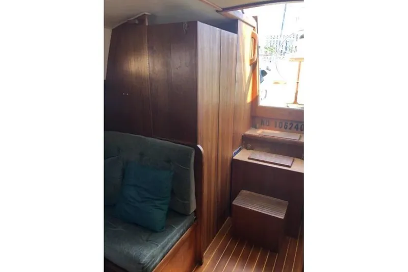 Slide: The Image of Interior of 1991 Caliber 33 sailboat with wooden cabinetry and cushioned seating. - 69
