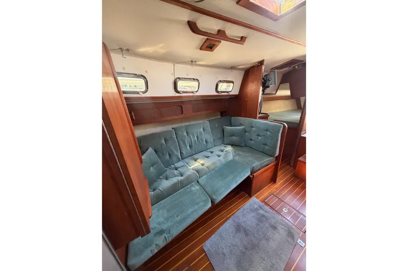 Slide: The Image of Interior of 1991 Caliber 33 sailboat with cozy seating and wooden flooring. - 47