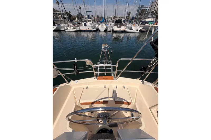 Slide: The Image of Cockpit view of 1991 Caliber 33 sailboat docked in a marina. - 18