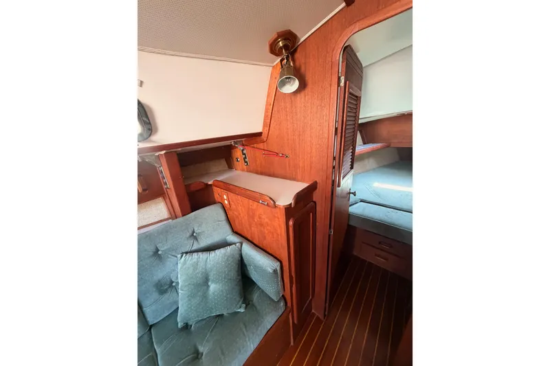 Slide: The Image of Interior of 1991 Caliber 33 sailboat with wooden cabinetry and cushioned seating. - 40