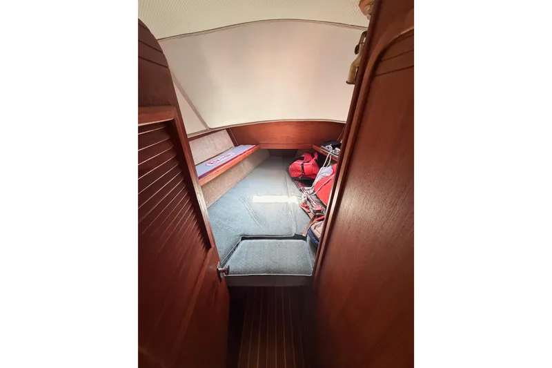 Slide: The Image of Cozy cabin interior of 1991 Caliber 33 sailboat with wooden finish and storage space. - 43