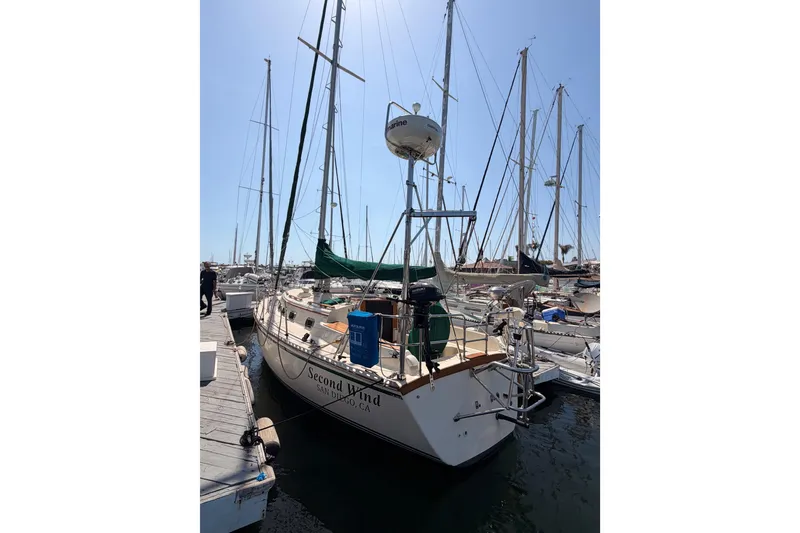 Slide: The Image of 1991 Caliber 33 sailboat docked in marina, named "Second Wind," San Diego, clear sky. - 51