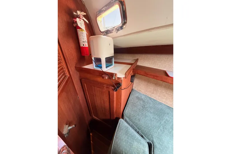 Slide: The Image of Cozy interior of 1991 Caliber 33 sailboat with wooden cabinetry and a fire extinguisher. - 45