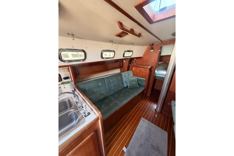 Slide: The Image of Interior of 1991 Caliber 33 sailboat with wood finish and cozy seating area. - 38