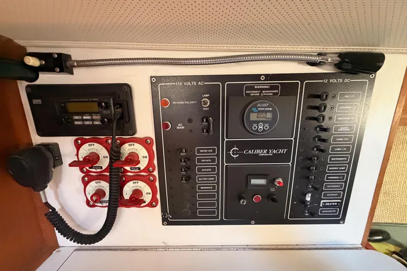 Slide: The Image of Electrical control panel of a 1991 Caliber 33 yacht, featuring switches and gauges. - 35