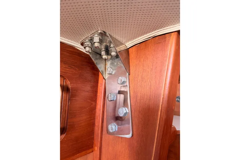 Slide: The Image of Stainless steel bracket on wooden interior of 1991 Caliber 33 boat. - 56