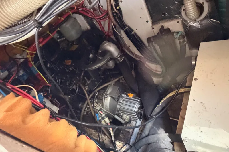 Slide: The Image of Engine compartment of a 1991 Caliber 33 sailboat, showing wiring and mechanical components. - 50