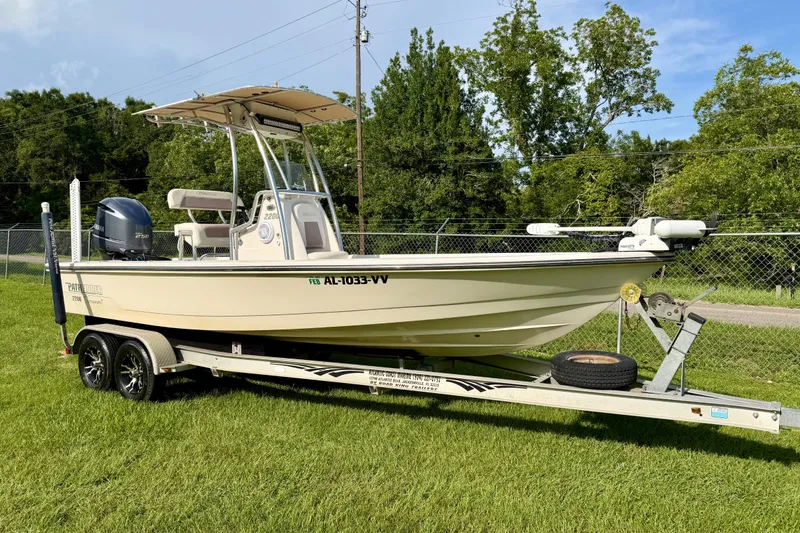 The Image of 2009 Pathfinder 2200 Tournament Edition boat on trailer, parked on grass. - 1