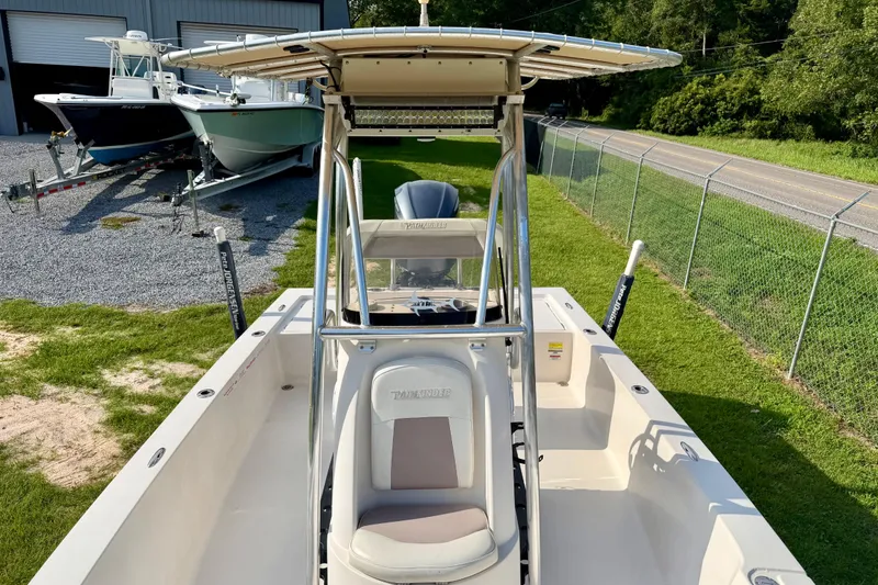 Slide: The Image of 2009 Pathfinder 2200 Tournament Edition boat with T-top, parked near other boats. - 11