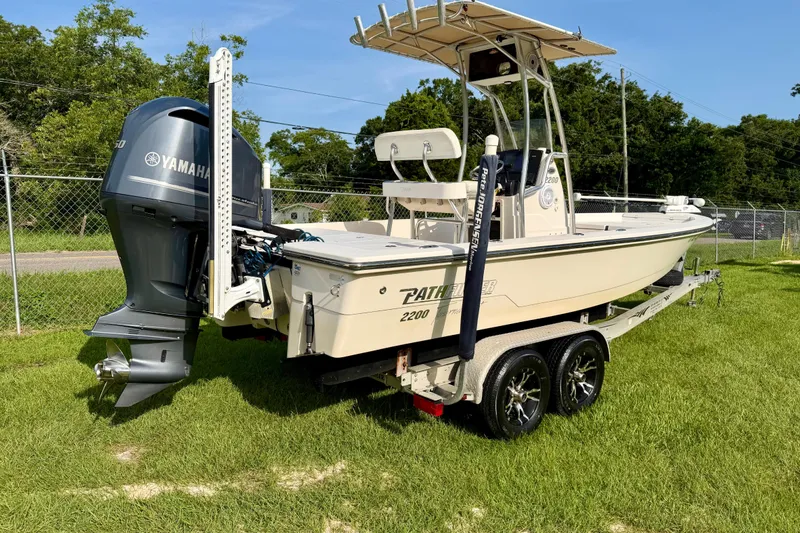 Slide: The Image of 2009 Pathfinder 2200 Tournament Edition boat on trailer with Yamaha engine, parked on grass. - 3