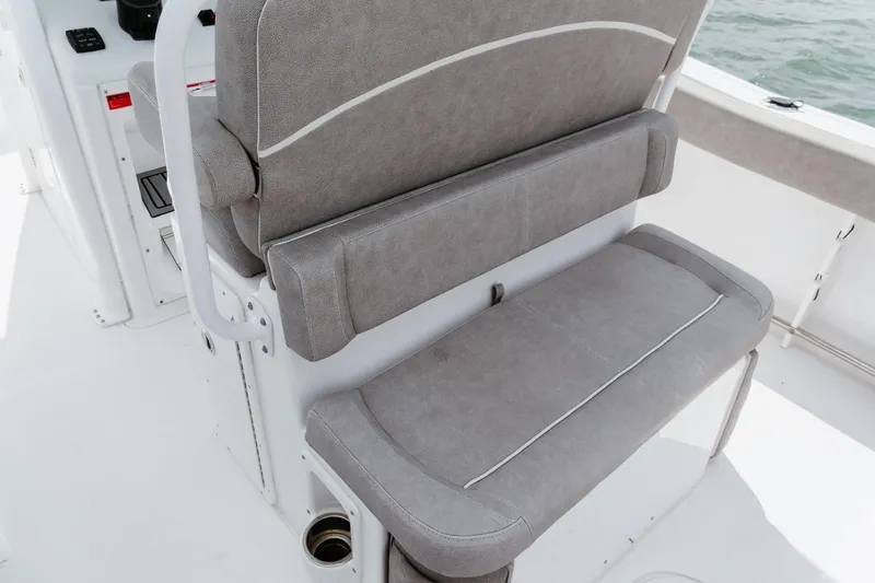 Slide: The Image of 2024 Sea Hunt Ultra 255 SE boat seating with gray upholstery and white accents. - 10