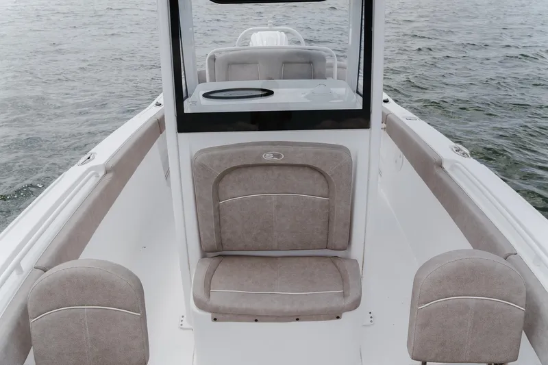 Slide: The Image of 2024 Sea Hunt Ultra 255 SE boat interior with cushioned seating on open water. - 11