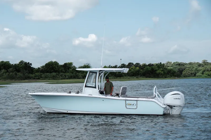 Slide: The Image of 2024 Sea Hunt Ultra 255 SE boat on water, featuring sleek design and Yamaha engine. - 7