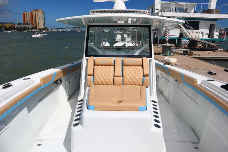 Slide: The Image of 2022 Yellowfin 42 Offshore boat with tan seating, docked in a marina. - 17