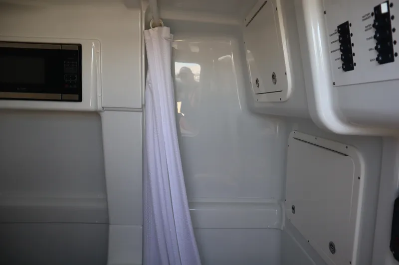 Slide: The Image of Interior of 2022 Yellowfin 42 Offshore boat with microwave and control panels. - 29