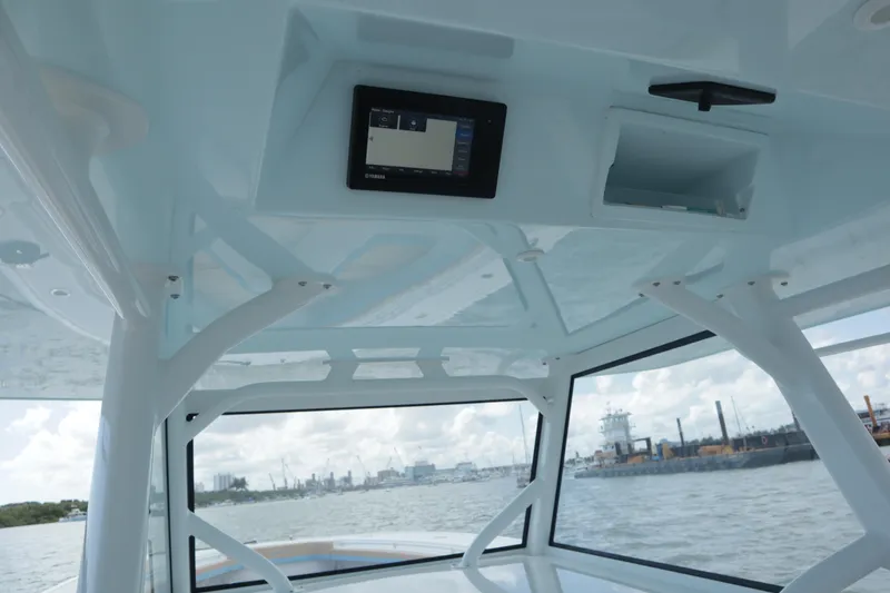 Slide: The Image of Interior view of 2022 Yellowfin 42 Offshore boat with electronic display and ocean backdrop. - 32