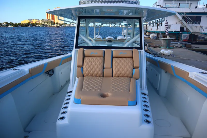 Slide: The Image of 2022 Yellowfin 42 Offshore boat with tan seating, docked by the water. - 45