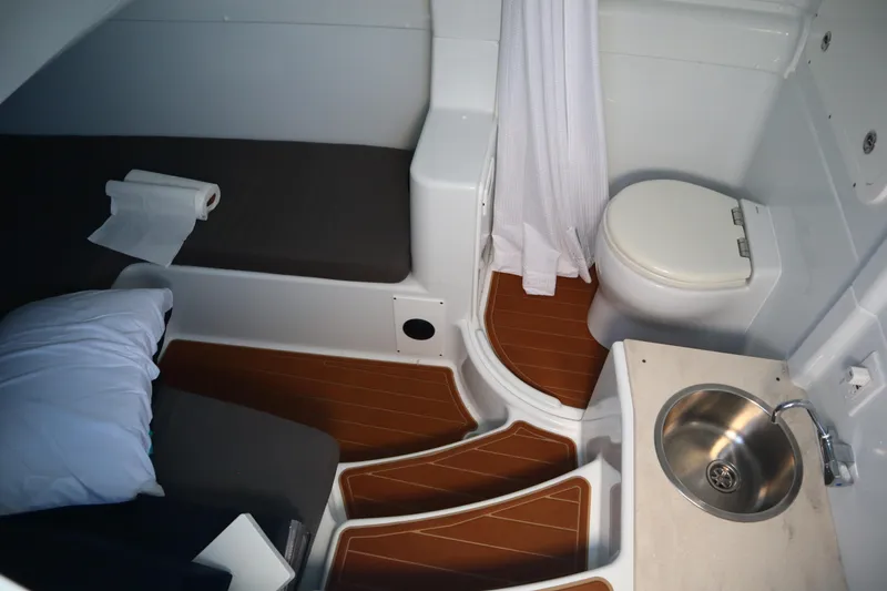Slide: The Image of 2022 Yellowfin 42 Offshore cabin with toilet, sink, and bed. - 47