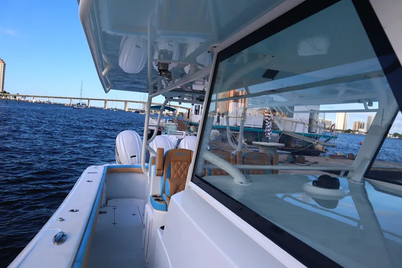 Slide: The Image of 2022 Yellowfin 42 Offshore boat docked by a waterfront with cityscape view. - 49