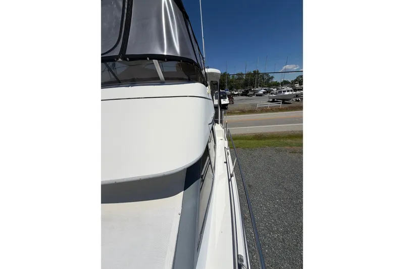 Slide: The Image of 1995 Carver 356 Aft Cabin Motor Yacht docked, side view under clear blue sky. - 12