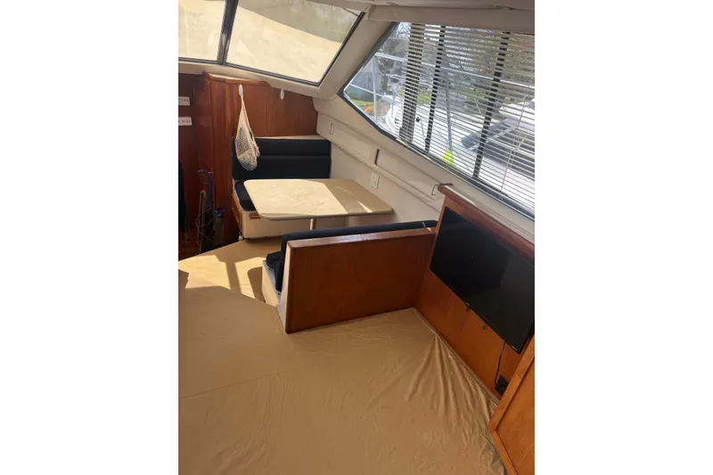 Slide: The Image of Interior of 1995 Carver 356 Aft Cabin Motor Yacht with dining area and windows. - 15