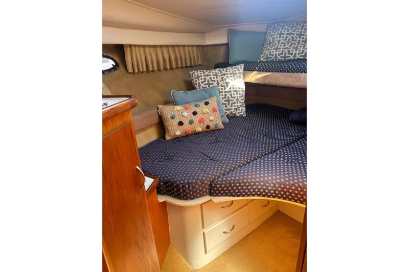 Slide: The Image of Cozy cabin interior of 1995 Carver 356 Aft Cabin Motor Yacht with patterned bedding. - 16