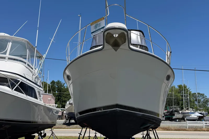 Slide: The Image of 1995 Carver 356 Aft Cabin Motor Yacht on display in a marina under clear blue skies. - 2
