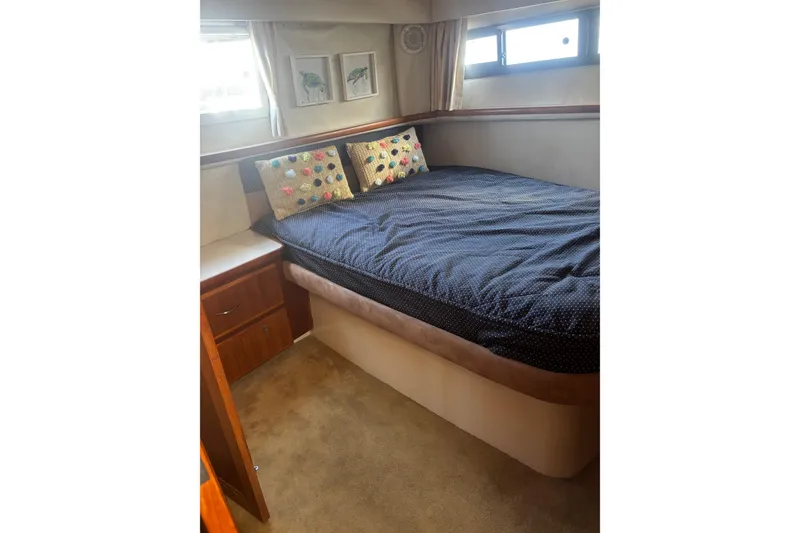 Slide: The Image of Cozy bedroom in 1995 Carver 356 Aft Cabin Motor Yacht with decorative pillows. - 20