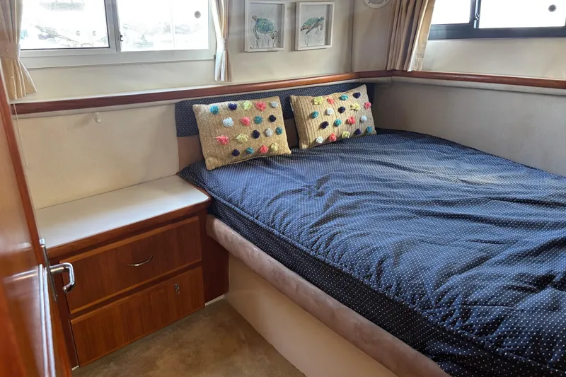 Slide: The Image of Cozy bedroom in 1995 Carver 356 Aft Cabin Motor Yacht with polka dot bedding. - 21