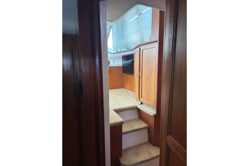 Slide: The Image of Interior of 1995 Carver 356 Aft Cabin Motor Yacht with wooden cabinetry and carpeted steps. - 23