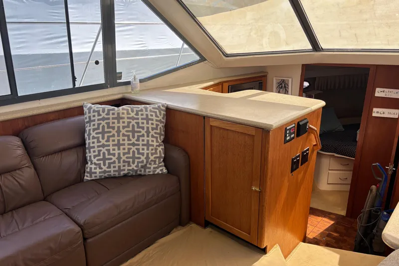 Slide: The Image of Interior of 1995 Carver 356 Aft Cabin Motor Yacht with leather sofa and wooden cabinetry. - 26
