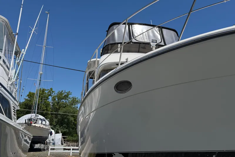 Slide: The Image of 1995 Carver 356 Aft Cabin Motor Yacht docked, showcasing sleek design and spacious cabin. - 3