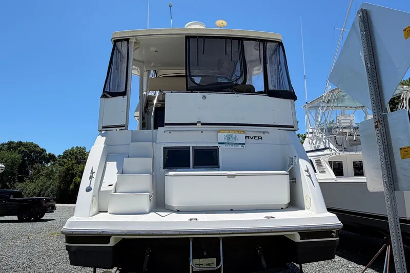 Slide: The Image of 1995 Carver 356 Aft Cabin Motor Yacht, docked, rear view, clear sky background. - 7