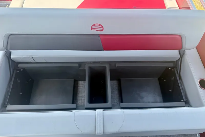 Slide: The Image of 2026 Sun Tracker Party Barge 22 RF XP3 storage compartments with red and gray seating. - 14