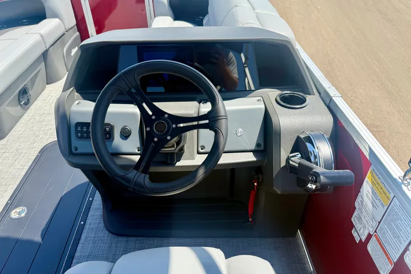 Slide: The Image of The image shows the helm of a 2026 Sun Tracker Party Barge 22 RF XP3. - 12