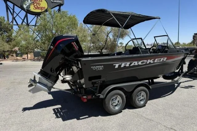 Slide: The Image of 2026 Tracker Targa V-19 Combo boat on trailer, parked outdoors under sunny skies. - 2